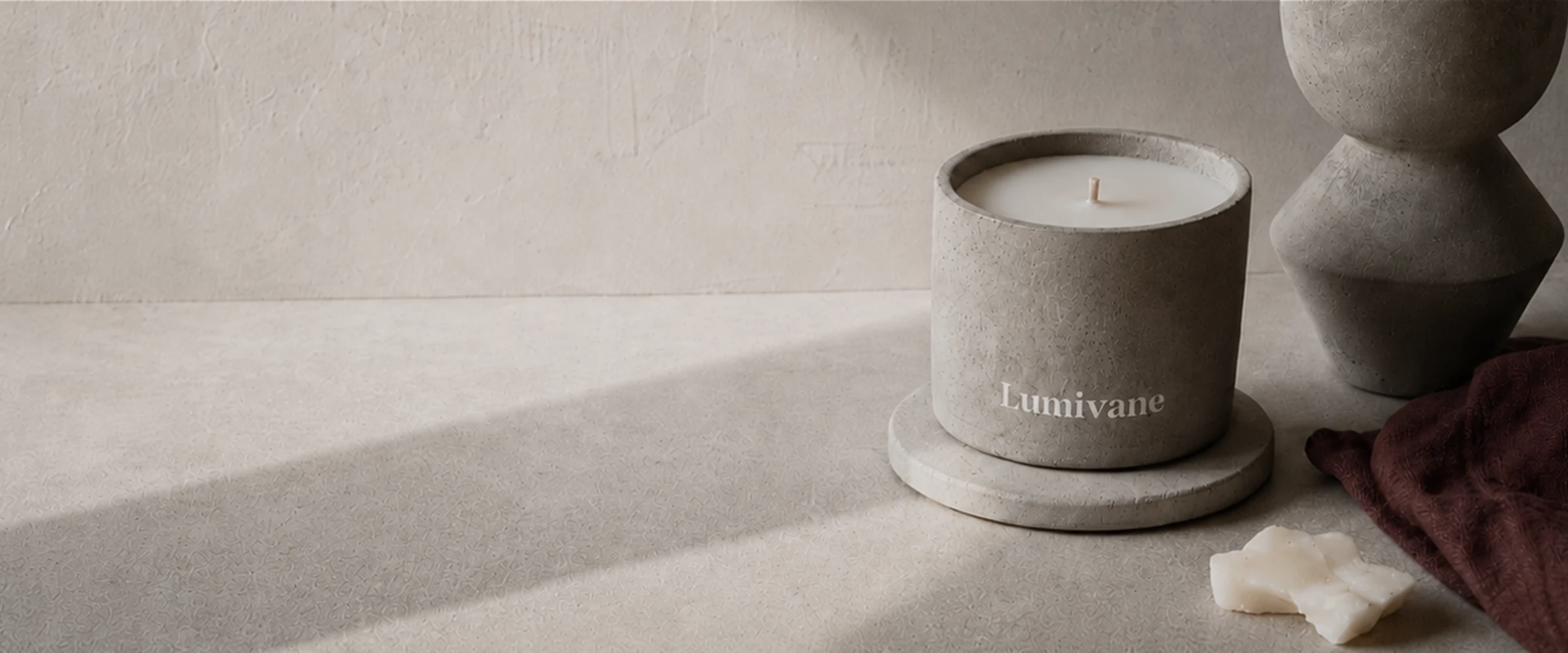 Lumivane candle in a hand-cast concrete vessel